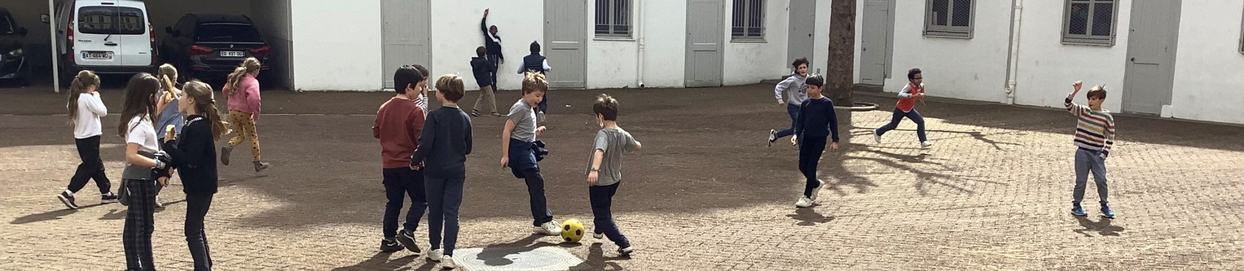 enfants jouant dans la cour du catéchisme.